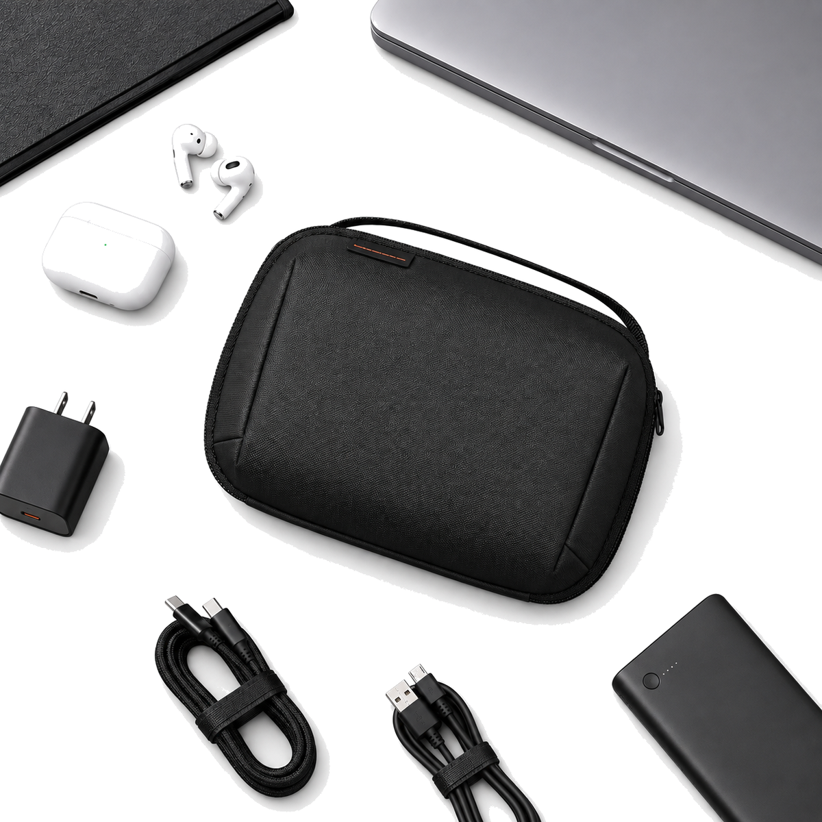 PackLite CordDock cable and tech organizer pouch flat lay with cables, charger and earbuds